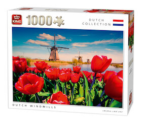 Pohled na nizozemské větrné mlýny skrze červené tulipány